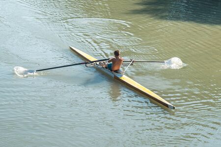 Teenage sportsmen in a boat, rowing on the river Rioni, Poti, Georgia.