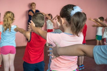 Teacher Taking Exercise Class In School Gym.の写真素材