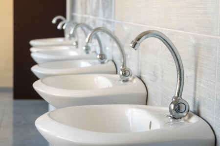 Public water taps in the school's toilet.の写真素材