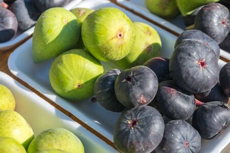 A background of fresh figs for sale at a market.