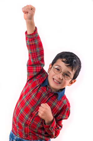 little boy in glasses raised his hands up. Isolated on white background. shooting in the studioの写真素材