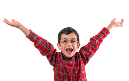 little boy in glasses raised his hands up. Isolated on white background. shooting in the studioの写真素材