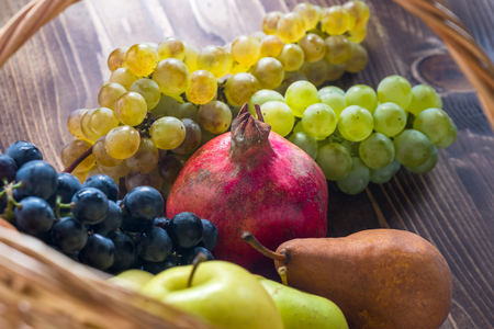 Composition with assorted fruits in wicker basket, healthy life.の写真素材