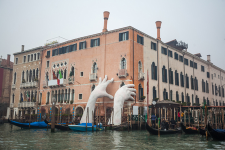 Giant hands rise from the water of the Grand Canal to support the building. Lorenzo Quinn.のeditorial素材