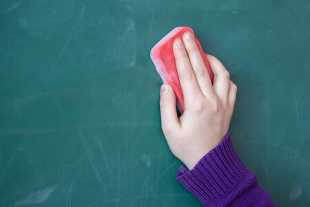 girls hand in elementary school cleaning board with sponge.の写真素材