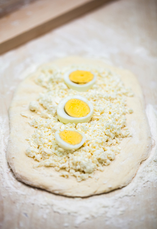 dough with cheese and egg for cooking traditional Georgian dish khachapuri  in a half moon form for christmas day, ghvezeli.の写真素材