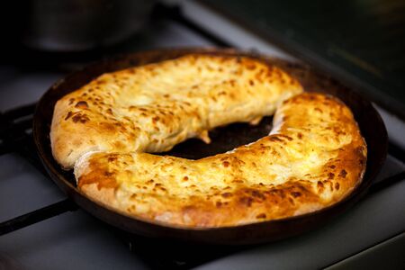 khachapuri (ghvezeli) in a half moon form for christmas day, Georgia.の写真素材