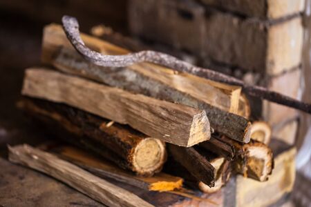 stone fireplace with firewood without fire, winter.の写真素材