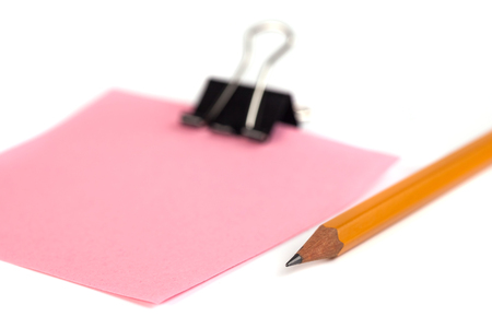 Black Paper clip and pink paper isolated on white background.の写真素材