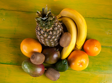 Tropical fruit on yellow wooden background, fresh food.の写真素材