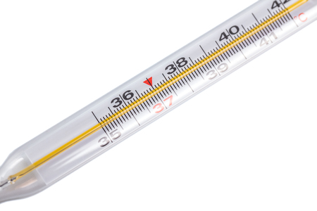 A glass thermometer for measuring the temperature of the human body, white background.の写真素材