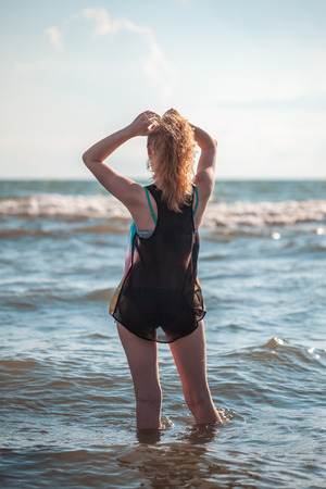 beautiful blonde girl in a shirt in the sea.の写真素材