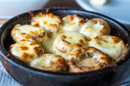 Stuffed mushrooms with cheese on the pot, Georgian cuisene.の写真素材