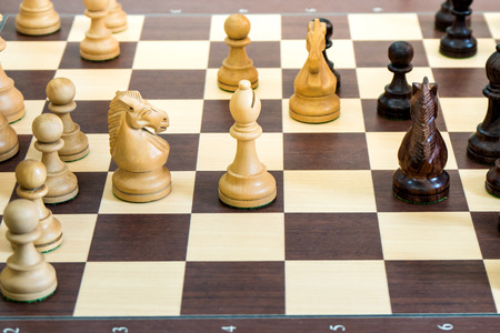 wood chess pieces on board game, sport.