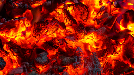 Background of burning hot coals, actively smoldering embers of fire.