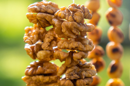 Walnuts halves on long thread - preparation blank for making churchkhela sweet dessert homemade...