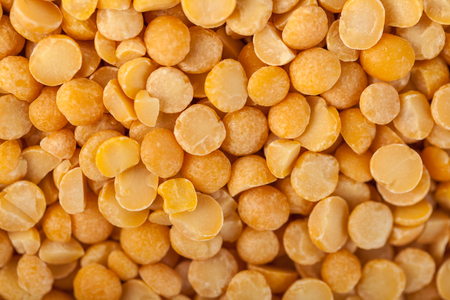 Yellow split mustard seeds for backgrounds or textures, healthy food.