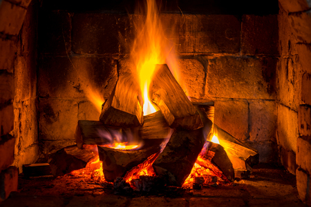 Wood burning in a cozy fireplace at home, keep warm.の写真素材