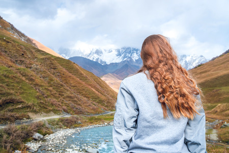 Beautiful girl on a mountain background of Svaneti, mountain Shkhara, relax while traveling.の写真素材