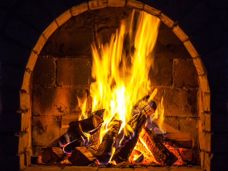 Wood burning in a cozy fireplace at home, keep warm.の写真素材