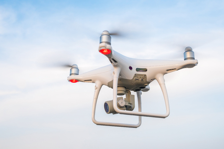 Flying drone with blue sky background.の写真素材