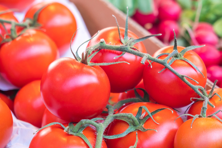 Fresh tomatoes in a market stall, healthy food.の写真素材