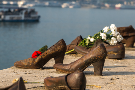 "Shoes on the Danube bank" - Monument as a memorial of the victims of the Holocaust during world war II on the bank of the Danube at sunset in Budapest, Hungary.のeditorial素材