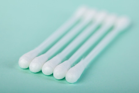 sticks for cleaning ears on a green background, medicineの写真素材