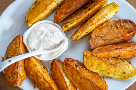 fried potatoes with Mexican sauce on the plate, traditional foodの写真素材