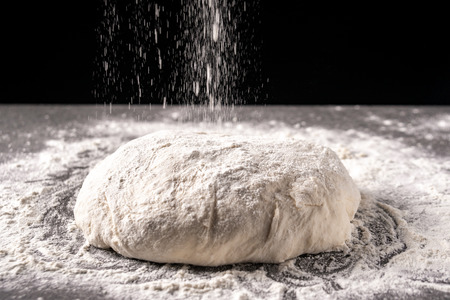 dough with flour on a black background, Dough ready for cooking