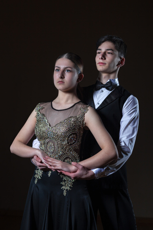 Beautiful young dancers in ballroom isolated on black background, couple danceの写真素材
