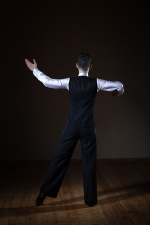 young dancer in the ballroom on a black background, classic danceの写真素材