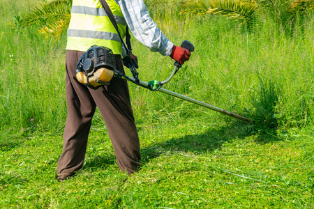 The gardener cutting grass by lawn mower, lawn care. Natureの写真素材