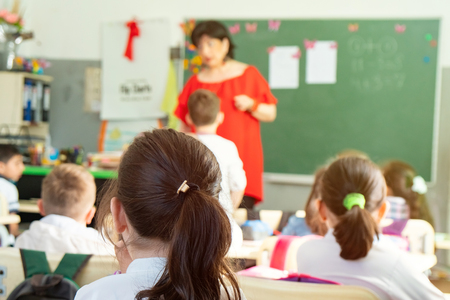 children actively participate in the class, read and listen to the teacher. Education.の写真素材
