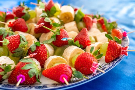 strawberries and other exotic fruits pinned with sticks, foodの写真素材