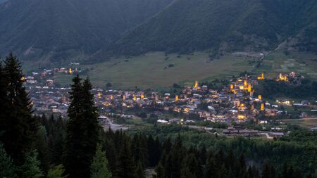 Night view on Mestia with its beautiful illuminated Svan Towers and high mountains. Svaneti, Georgia. Travel.の写真素材