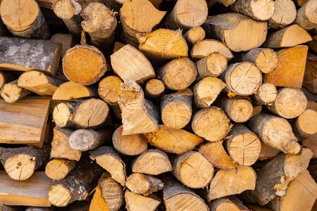 Splited firewood for fireplace or stone campfire stacked together. Tree.