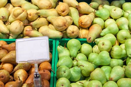pears at the grocery store. lots of pears harvest collected in bins at production stage. Food.の写真素材