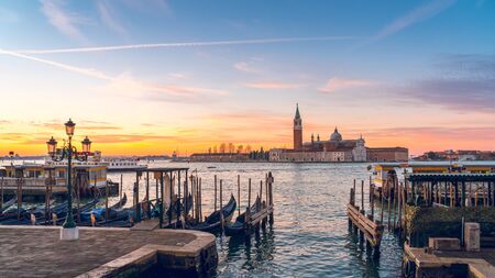 Sunrise in Venice, gondolas and island of St. George view from the square San Marco. Travel.