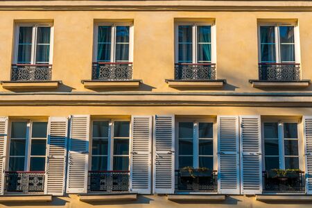 Typical facade of Parisian building with window wrought iron fences. France. Architecture.の写真素材