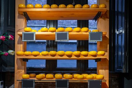 Holland cheese wheels on the shelves in diary production market. Food.の写真素材