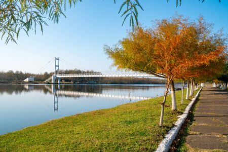 Beautiful view of "gold lake" and white iron bridge in Maltakva park, Poti, Georgia. Landscape.の写真素材