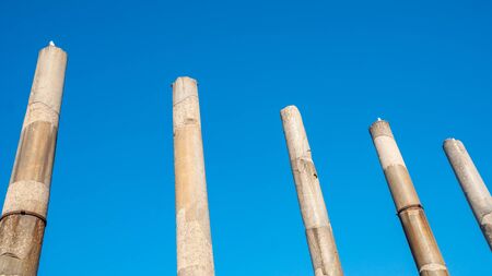 antique columns against the blue sky, the historical part of the city of Rome. History.の写真素材
