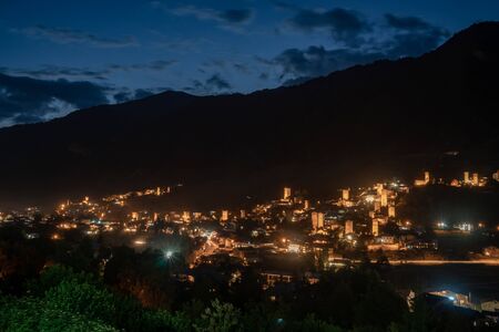 Night view on Mestia with its beautiful illuminated Svan Towers and high mountains. Svaneti, Georgia. Travel.の写真素材
