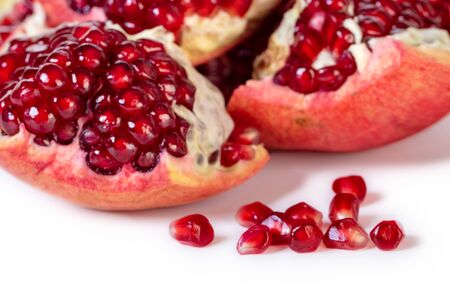 Ripe pomegranate fruit with red seeds isolated on white background.の写真素材
