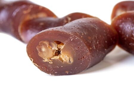 Traditional Georgian homemade sweets with walnuts and grape juice Churchkhela isolated on white backgroundの写真素材