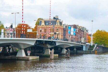 Amsterdam, Netherlands 15 October 2019 - Amsterdam canals with boats and typical houses. Travel.のeditorial素材
