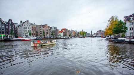 Amsterdam, Netherlands 15 October 2019. Amsterdam canals with boats and typical houses. Travel.