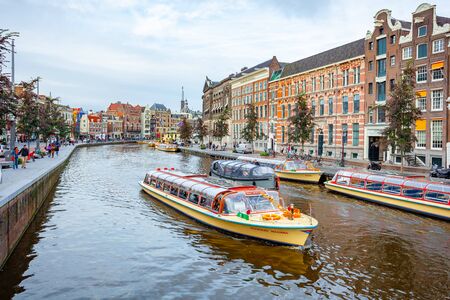 Amsterdam, Netherlands 15 October 2019. Amsterdam canals with boats and typical houses. Travel.のeditorial素材