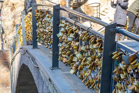 Tbilisi, Georgia 26 January 2020 - Golden love padlocks on Bridge near Legvtakhevi canyon in the Bath District Abanotubani of Tbilisiのeditorial素材
